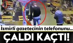 Gazetecinin telefonunu ceketiyle gizleyerek çaldı